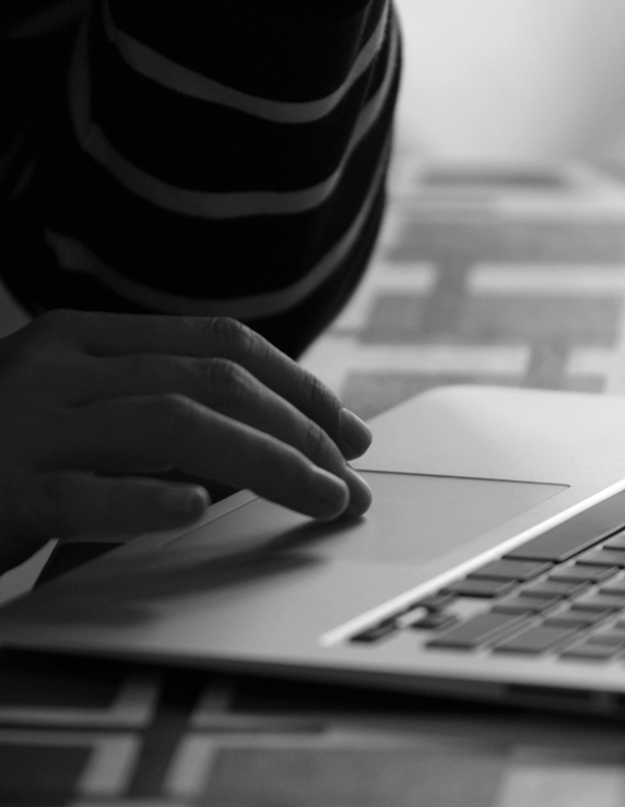 A person using the trackpad on a laptop