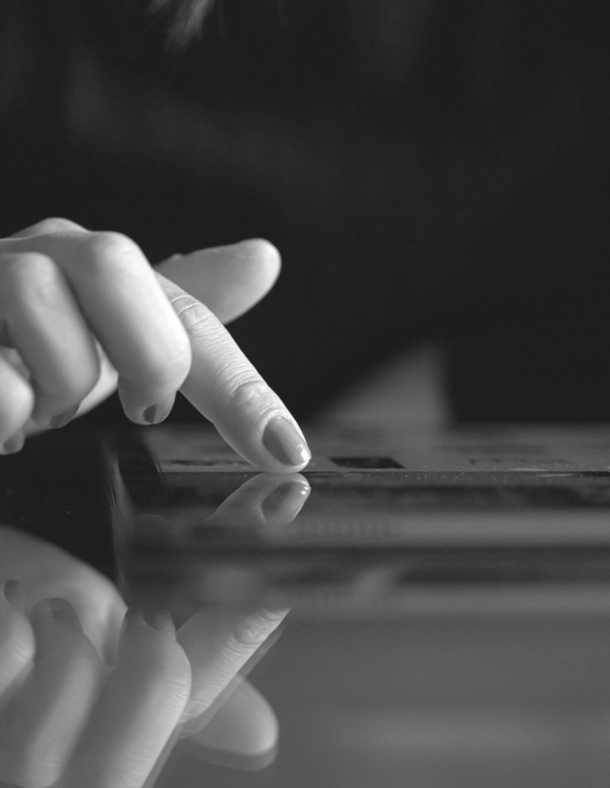 A hand using a touchscreen tablet