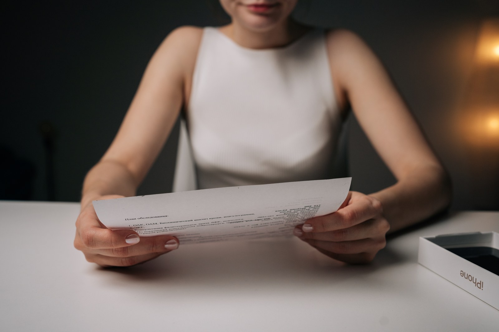 A woman reviewing paperwork at a desk